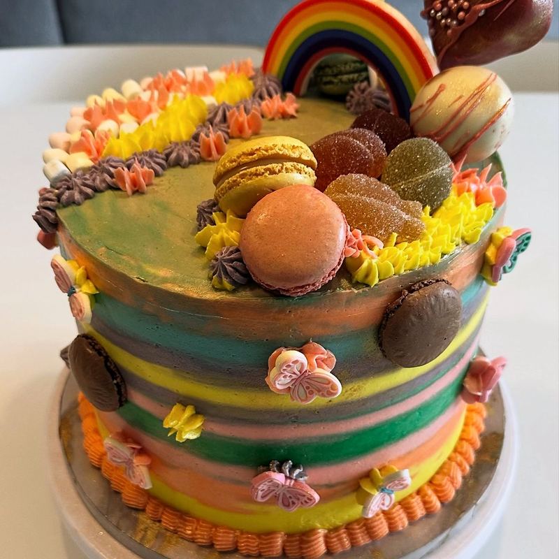 Rainbow layer cake with macarons and meringues
