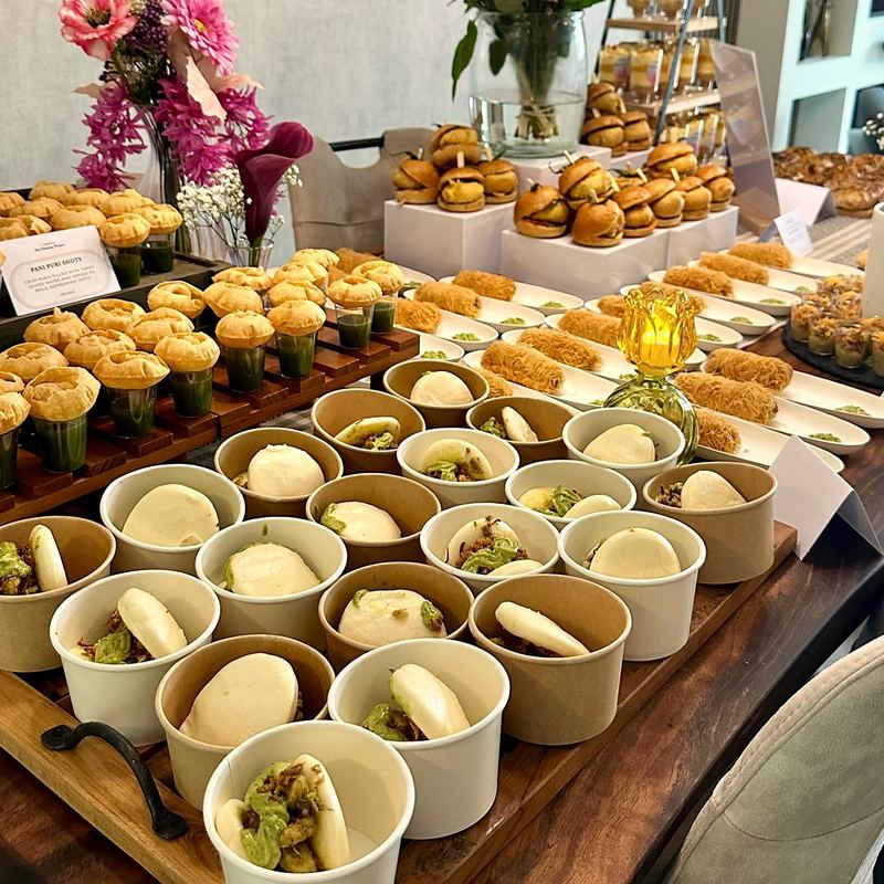 Birthday grazing table with flowers, savoury cups and bao buns